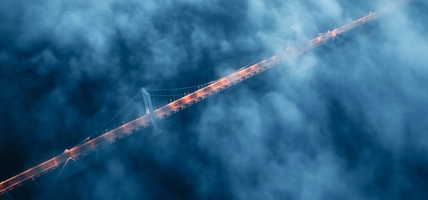 A cross-sea bridge in the fog at night
