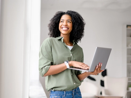 Radiant African-American woman casually handles laptop